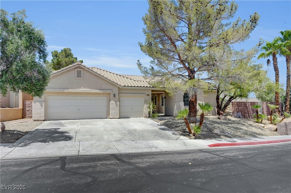 Single story home with a garage, driveway, stucco