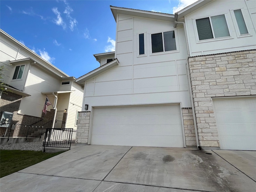 View of front facade with concrete driveway, ston