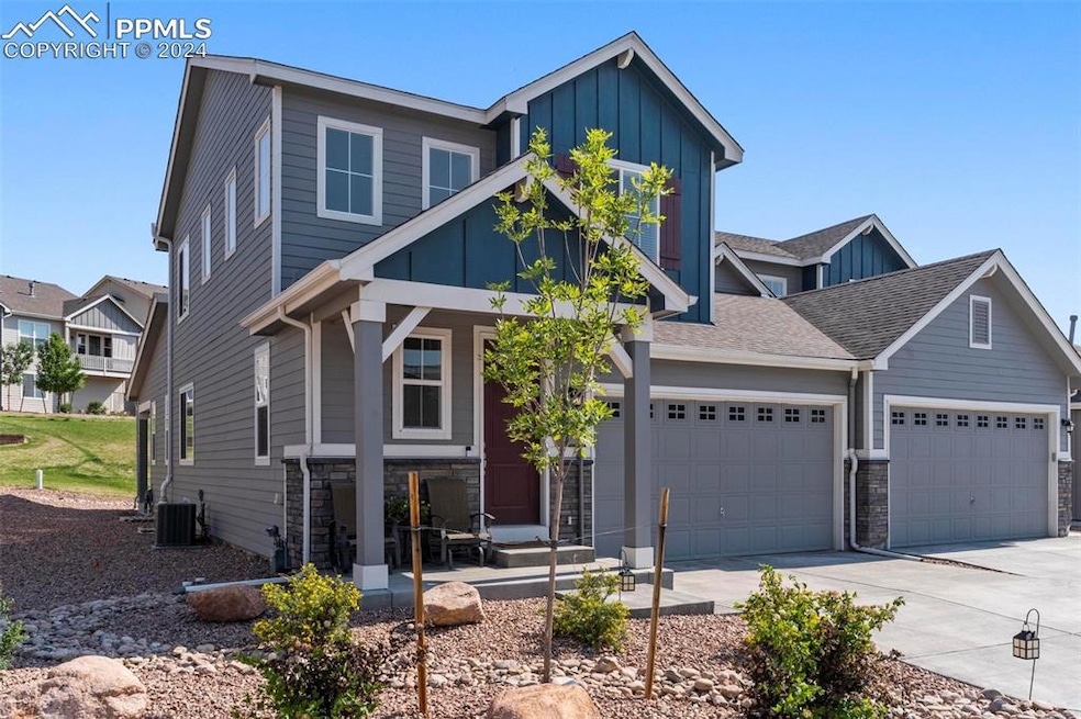 View of front of home with a garage and central ai