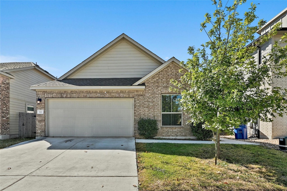 View of front facade featuring brick siding, concrete driveway, a garage, a front lawn