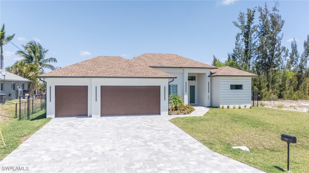 View of front facade featuring a garage, stucco si