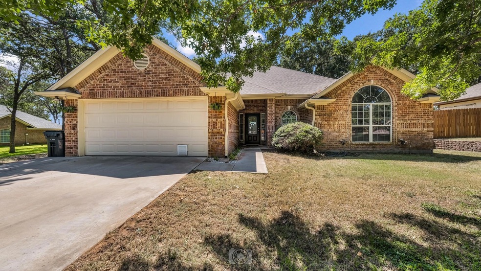 View of front facade with a front lawn and a garage