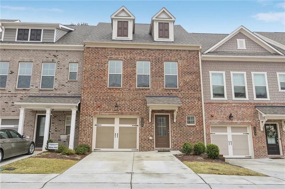 Brick front property featuring a shingled roof, co