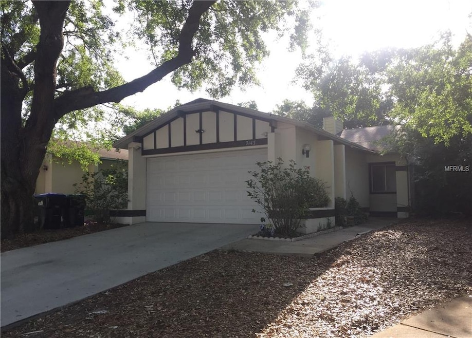 FRONT EXTERIOR. WALKWAY TO THE RIGHT TO COVERED ENTRY. NEWER CONCRETE DRIVEWAY. TWO-CAR GARAGE