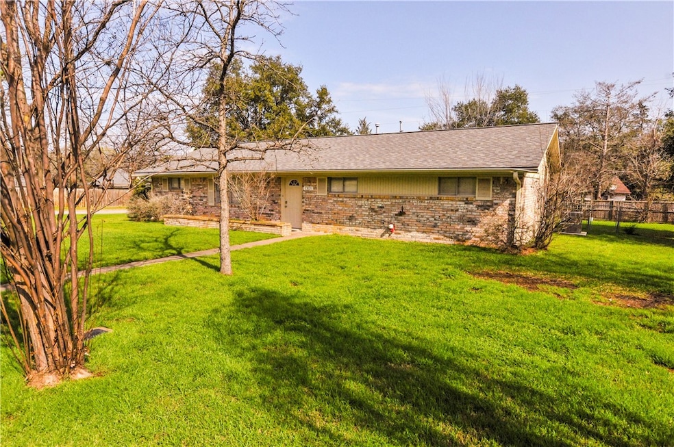 Back of property featuring a lawn