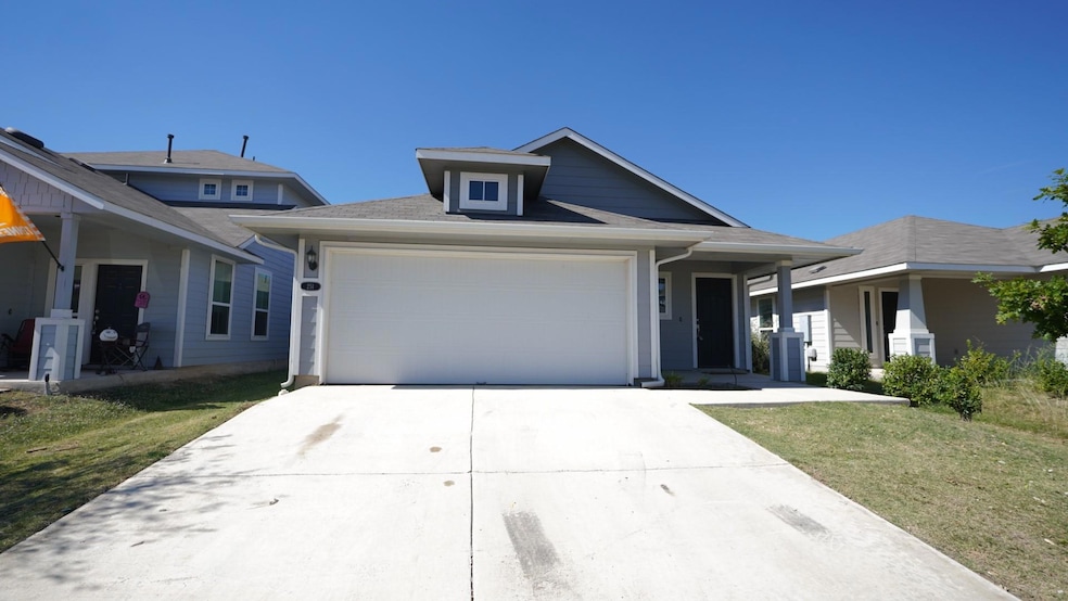 View of front of house with driveway, a garage, a front lawn, and a shingled roof