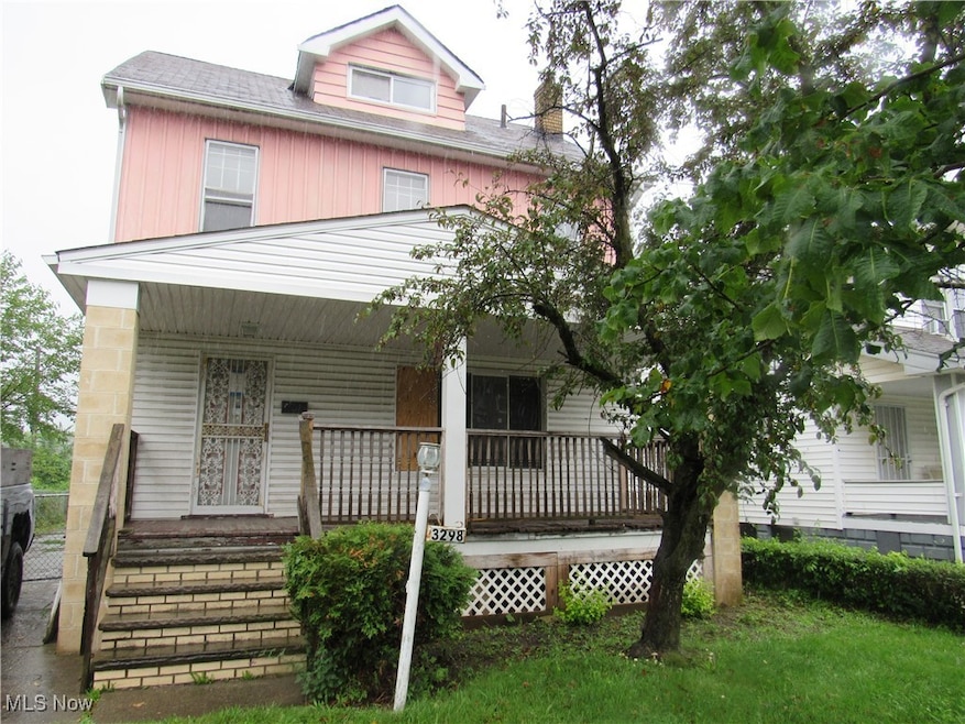 View of front of home with covered porch, a shingled roof, and a chimney