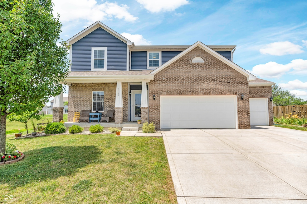 view of front of home featuring covered porch, brick siding, a garage, concrete driveway, and roof with shingles