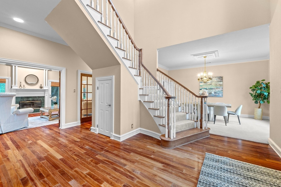 Staircase with baseboards, ornamental molding, an
