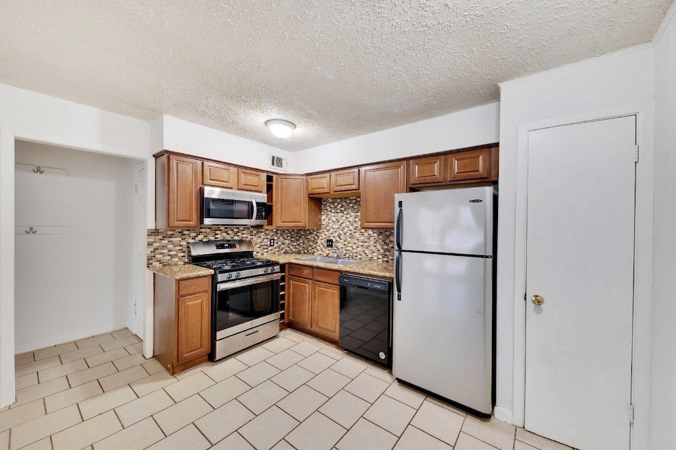 Kitchen featuring stainless steel appliances, a s