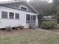 Back of property with a lawn
