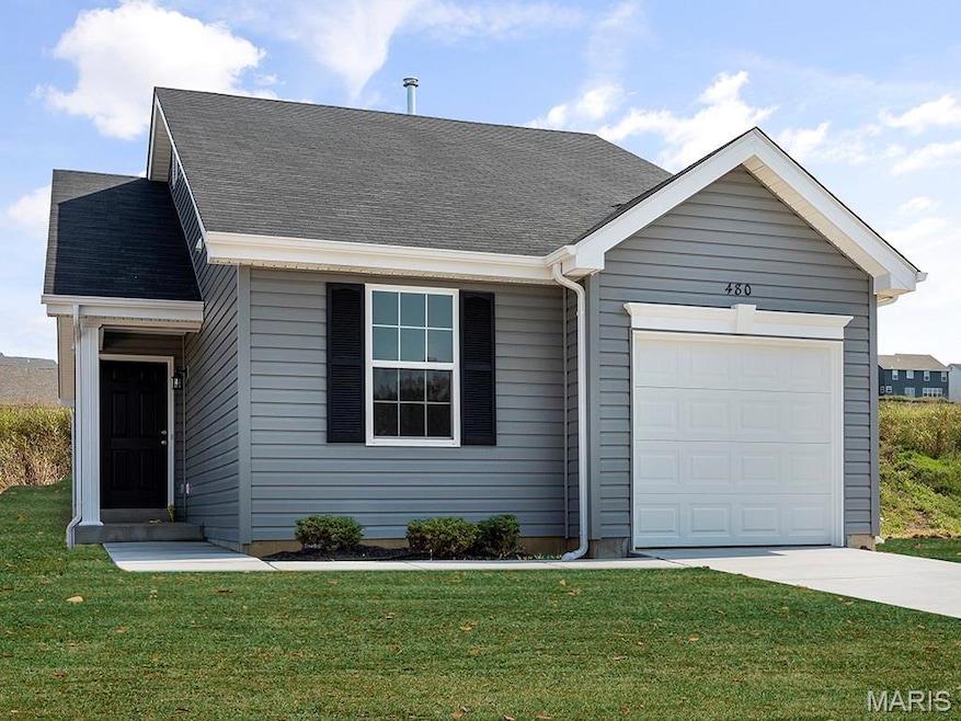 Single story home featuring an attached garage, a front lawn, concrete driveway, and roof with shingles