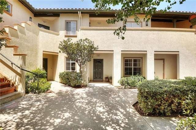 Front door accessed through well-manicured courtya