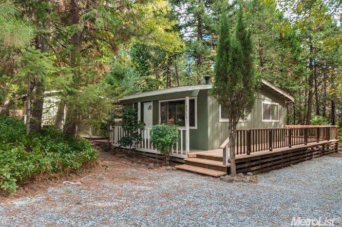 NESTLED IN THE TREES ON ALMOST AN ACRE.