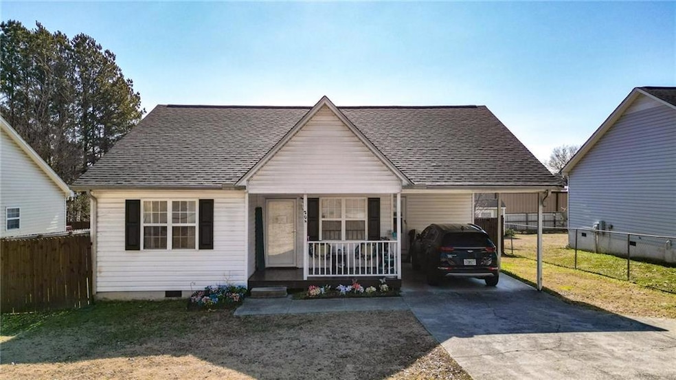 Bungalow with a front yard, a carport, and covered