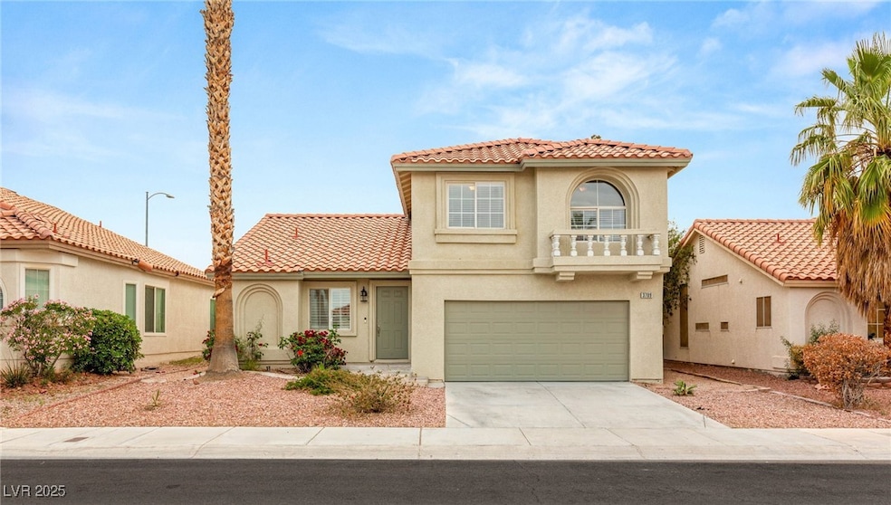 Mediterranean / spanish-style home featuring a gar
