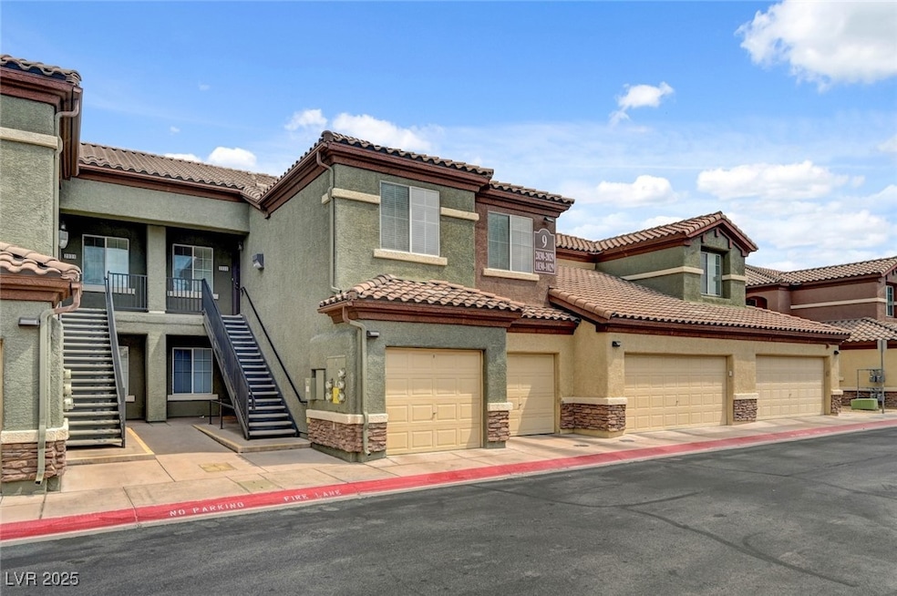 Mediterranean / spanish-style home with stucco siding, stone siding, a tile roof, and stairway