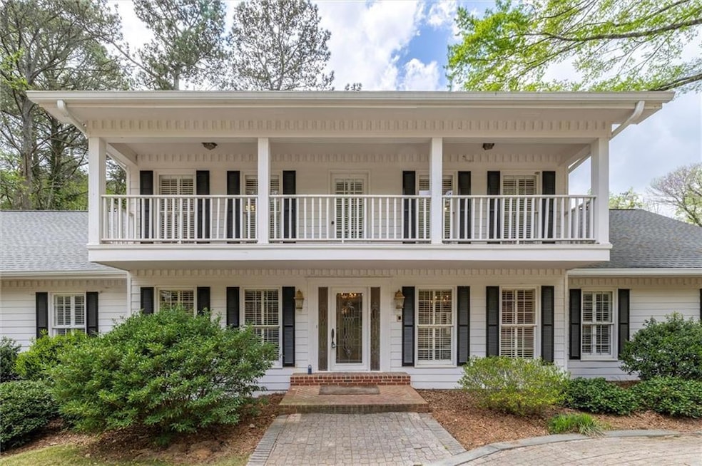 View of front of property featuring a balcony, a p