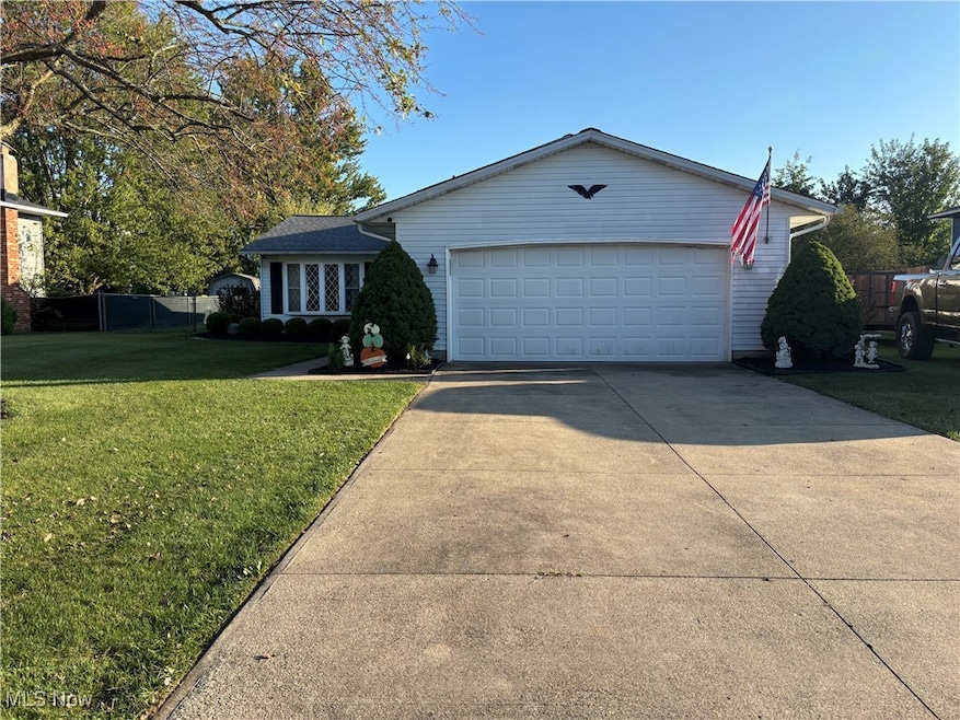 View of front of house with driveway and a garage