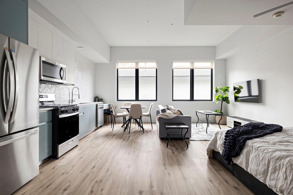 Bedroom featuring freestanding refrigerator, ligh