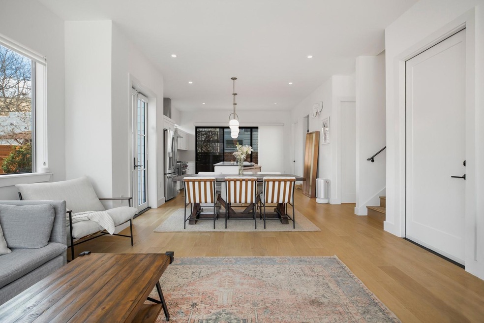 Dining room with light wood finished floors, stai