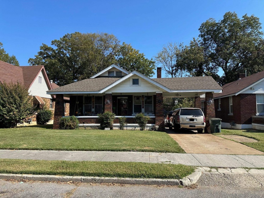 View of front of property with a front yard, a por