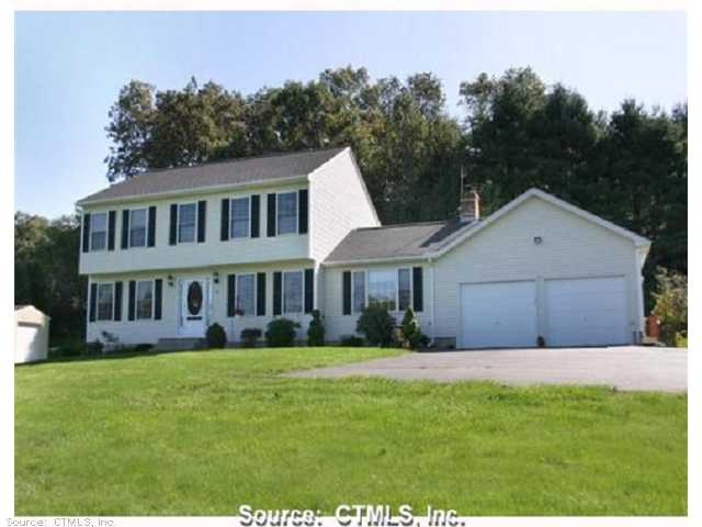 Exterior Front. Sweeping asphalt driveway brings y