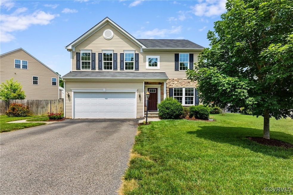 Traditional-style home with asphalt driveway and a