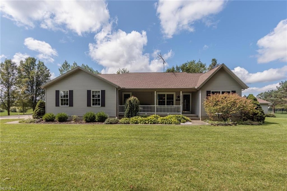 Ranch-style home featuring a front yard and a porc