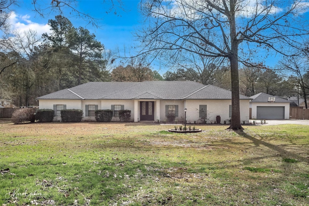Single story home featuring a garage and a front l