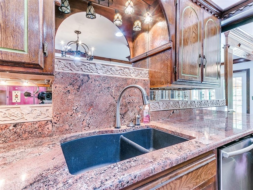 Kitchen featuring tasteful backsplash, a chandelie