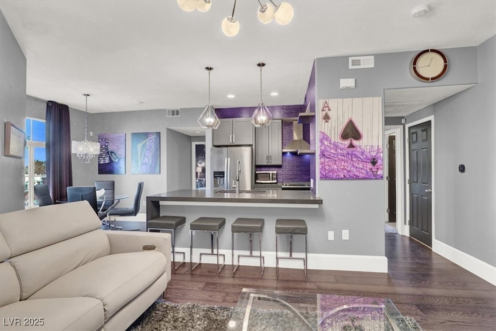 Living area featuring visible vents, dark wood fin