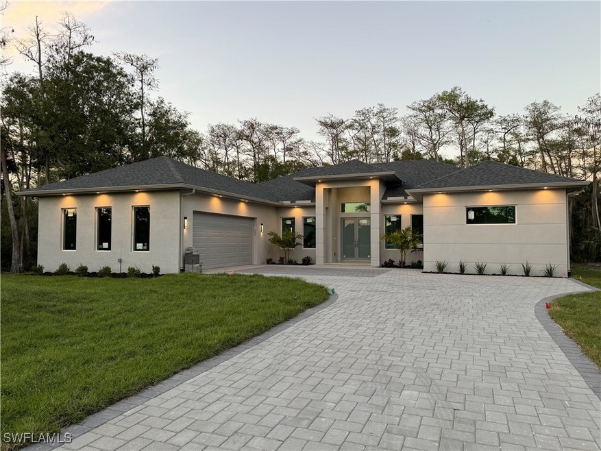 Prairie-style home featuring a garage, stucco sidi