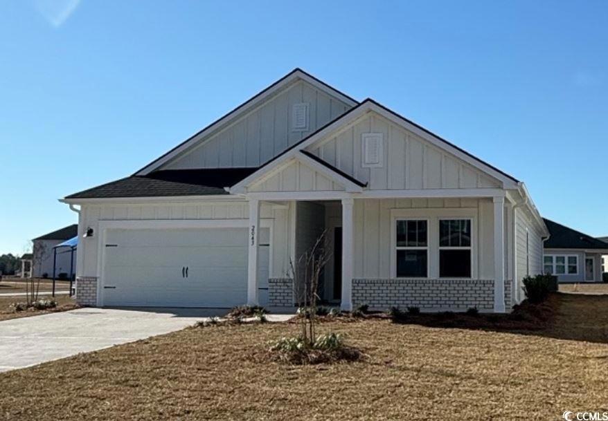 View of front of home featuring a garage, concrete