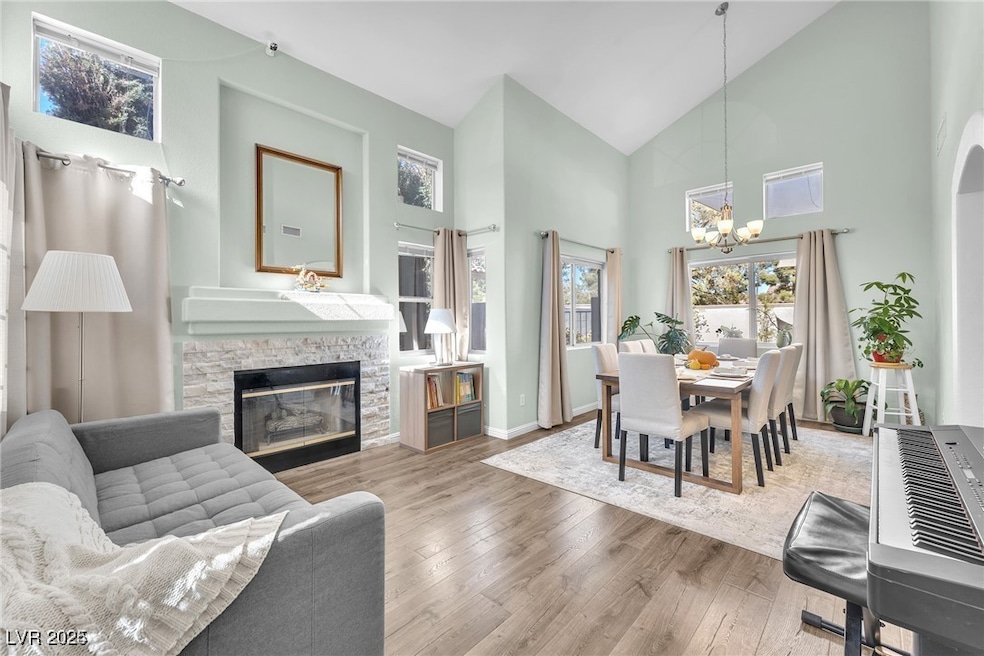 Living room with high vaulted ceiling, a chandelie