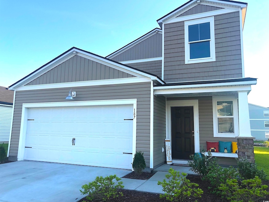 View of front of home with driveway and a garage