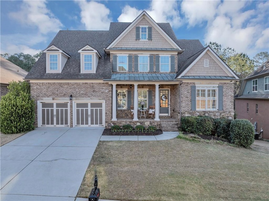 Craftsman-style house featuring driveway, an attac
