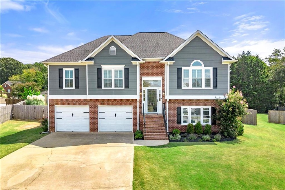 Bi-level home featuring a front lawn and a garage