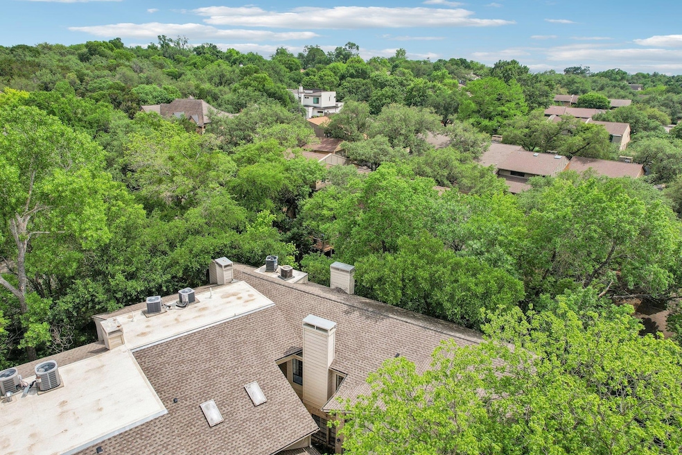 Birds eye view of property featuring a wooded view