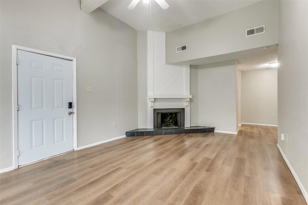Unfurnished living room featuring high vaulted cei