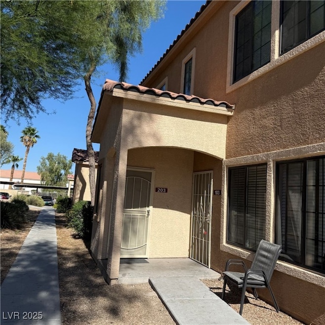 Doorway to property featuring a tiled roof and stucco siding