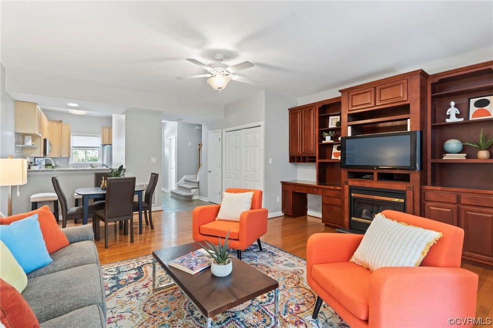 Living room featuring ceiling fan and light hardwo