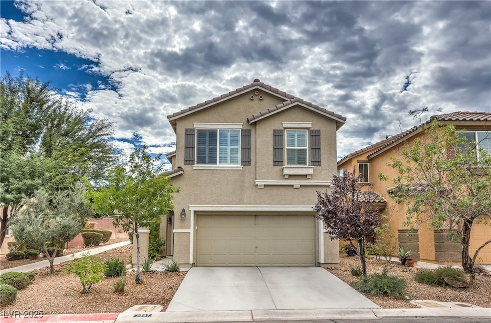 View of front of home featuring stucco siding, concrete driveway, and an attached garage