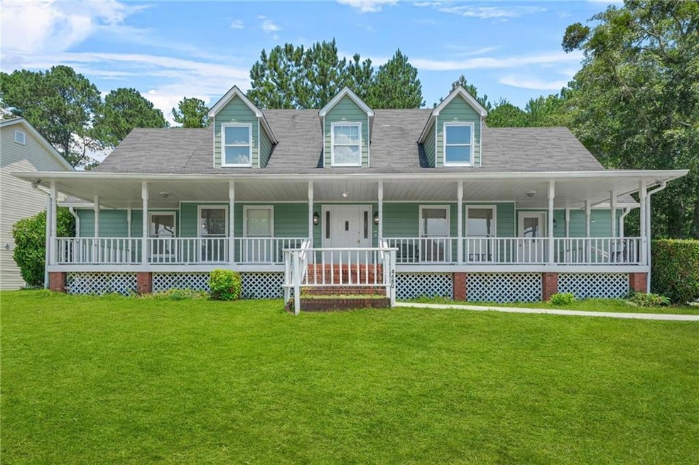 Farmhouse inspired home with a front yard, a porch, and roof with shingles