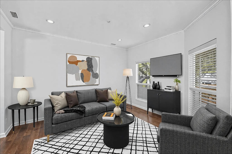 Living area featuring ornamental molding, wood fi