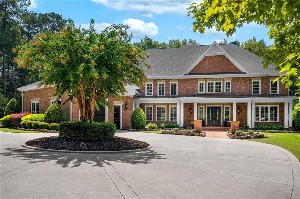This fully custom brick estate combines timeless craftsmanship with resort-style amenities and an extraordinary 9+-car garage complex designed for the auto aficionado.