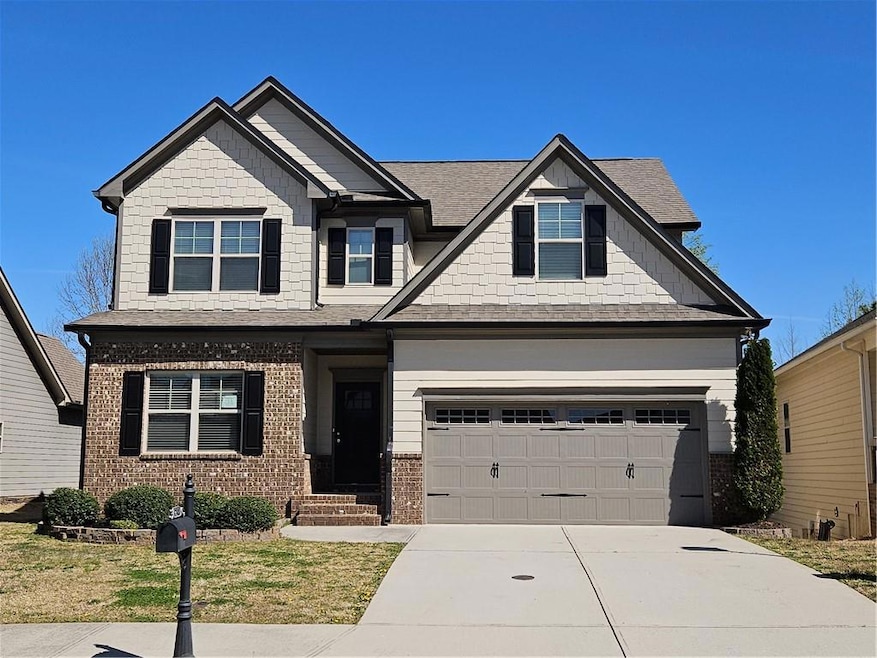 Craftsman-style house with a garage, brick siding,