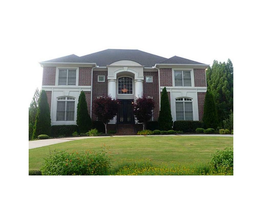 Exterior Front. Three sides brick with side entry 