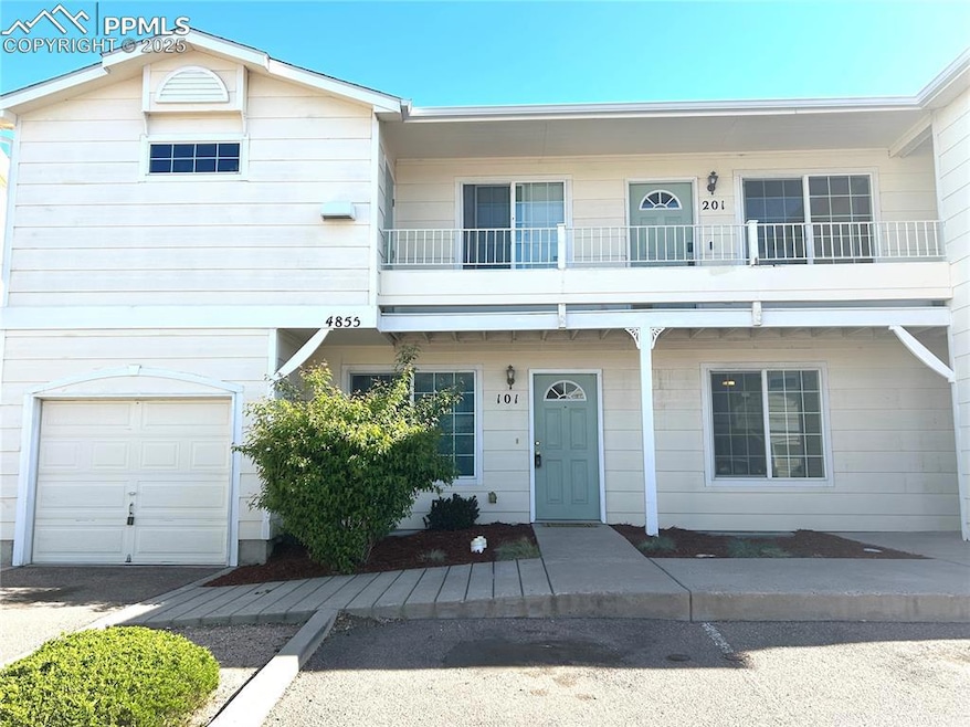 Townhome / multi-family property featuring an atta