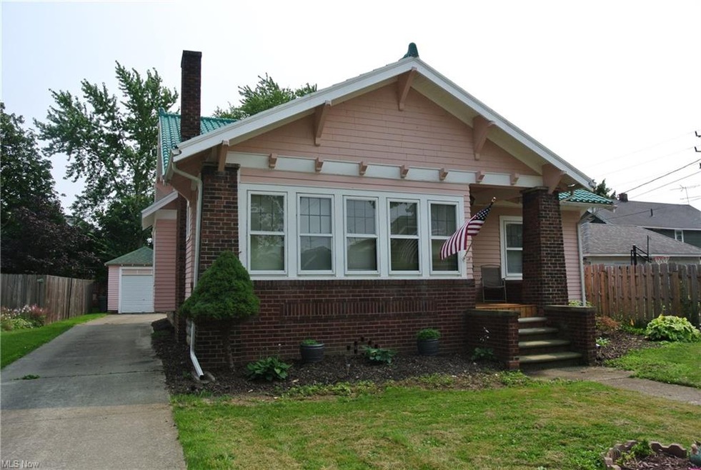 Front view of home with detached garage